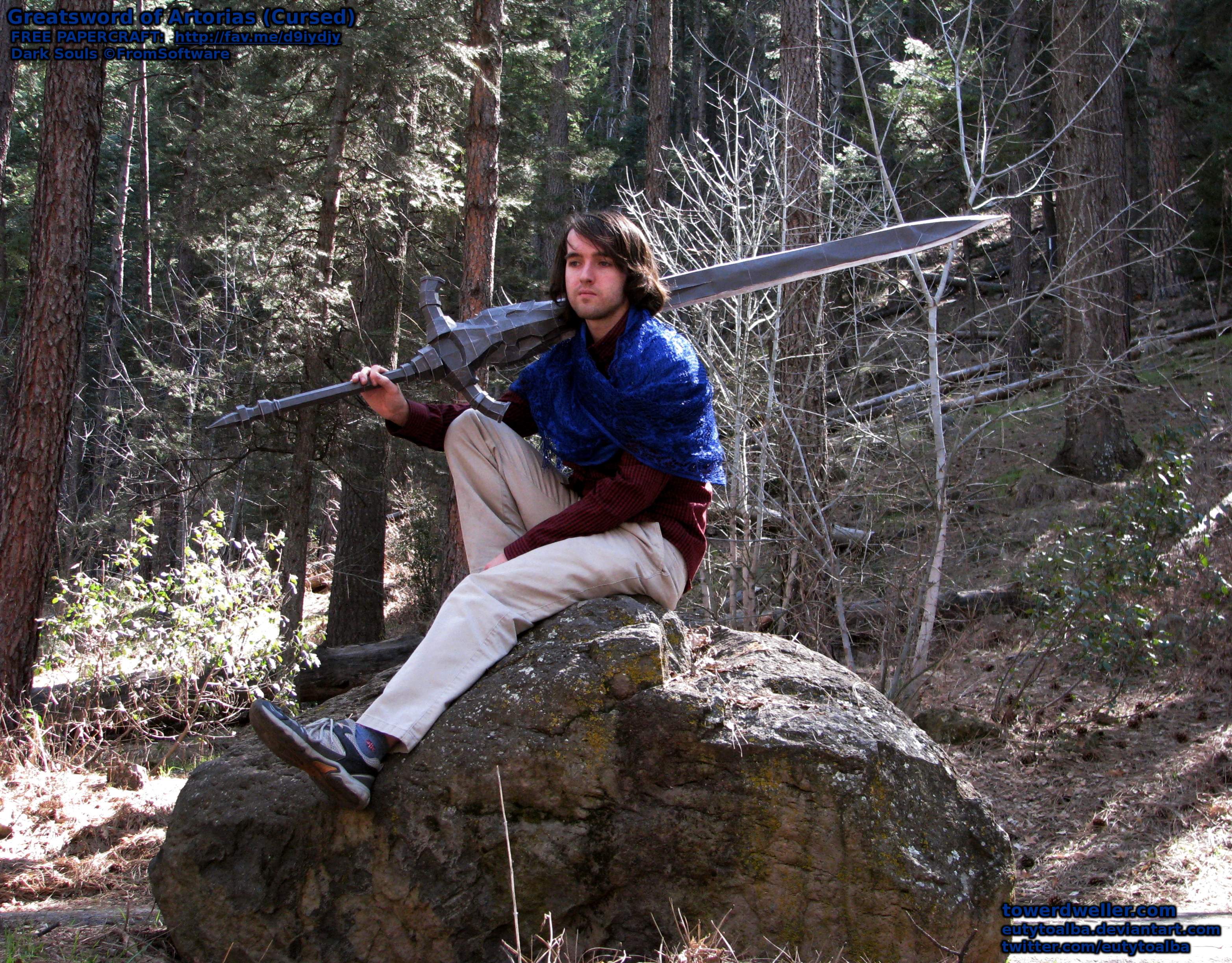 My meticulously scaled (accurately life-size!) Cursed Greatsword of Artorias papercraft, BEFORE fiberglass resin has been applied to it. (And held, in this case, by my brother.) In this pic, it's just "110lb" paper + a lightweight steel tomato plant stake, and probably still weighed under 1.5lbs. as a whole. Pic taken near Sedona, Arizona, USA, during a recent road trip.